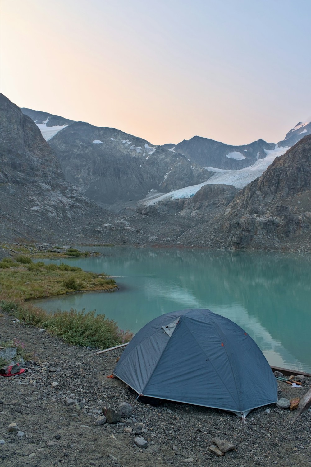 Tent pitched beside an alpine lake